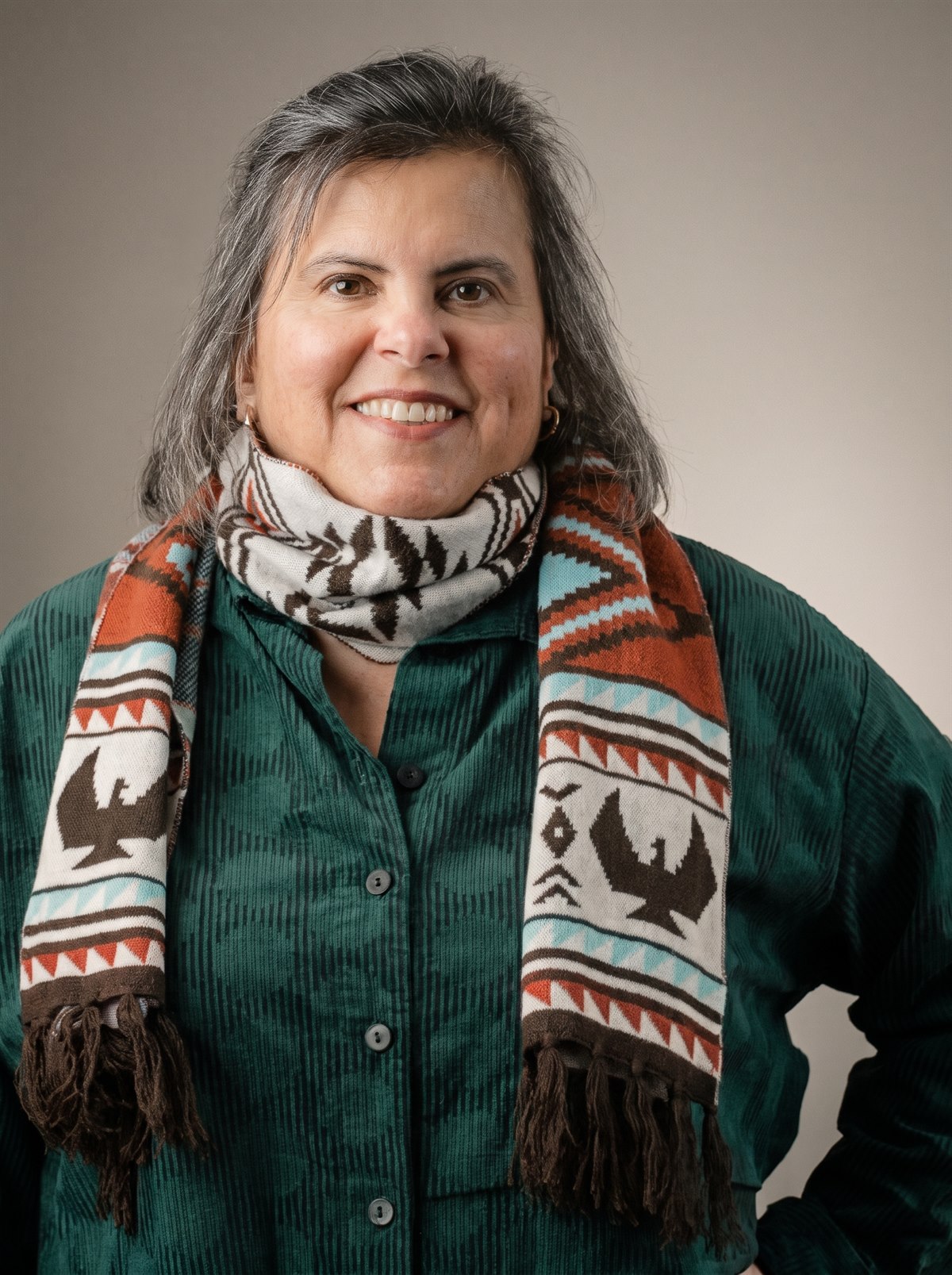 Gwen Shandroski, smiling, in a green shirt and patterned scarf